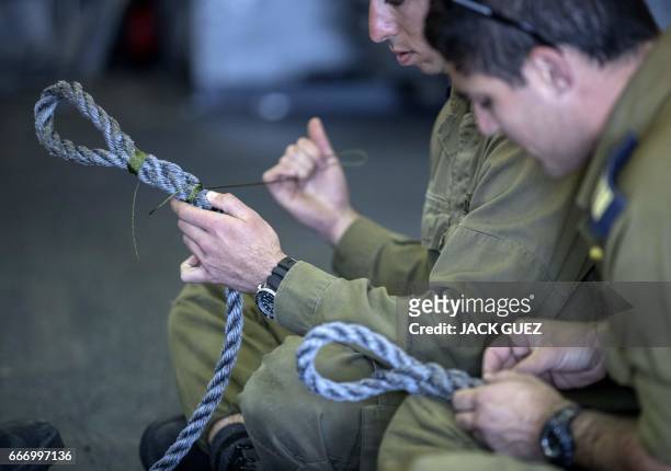 Israeli officers onboard the Israeli vessel Saar 5 Class Corvette "INS Hanit" practice new rope-nodes during the "Novel Dina 17" training session in...