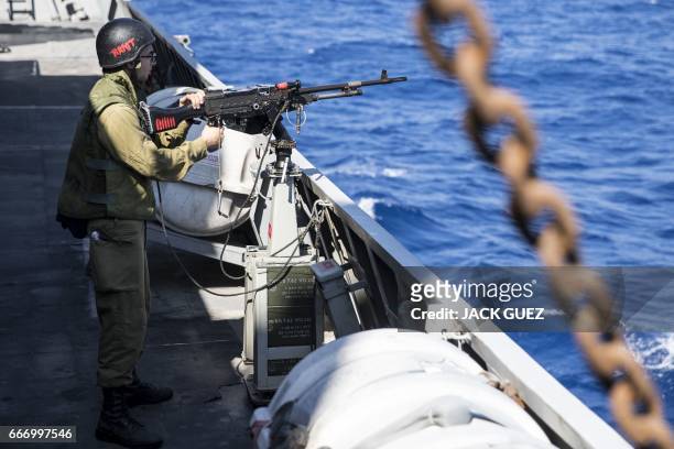 An Israeli soldier onboard the Israeli vessel Saar 5 Class Corvette "INS Hanit" takes part in the "Novel Dina 17" training session in the...