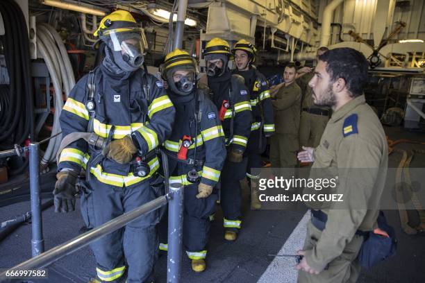 Israeli soldiers onboard the Israeli vessel Saar 5 Class Corvette "INS Hanit" take part in a fire evacuation excercise during the "Novel Dina 17"...