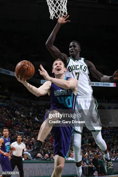 OMilwaukee, WI Cody Zeller of the Charlotte Hornets goes to the basket against Thon Maker of the Milwaukee Bucks on April 10, 2017 at the BMO Harris...