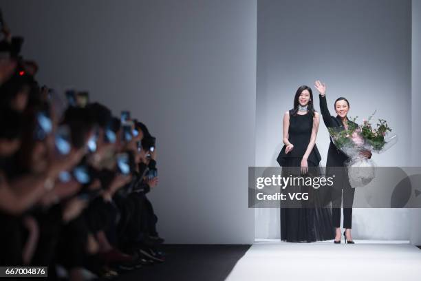 Fashion model Ming Xi Mengyao and actress Carina Lau attend ANIRAC collection by Carina Lau during the Shanghai Fashion Week Autumn/Winter 2017 at...