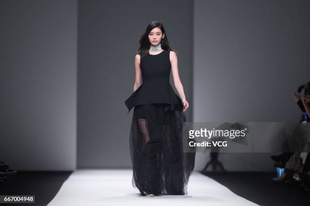 Fashion model Ming Xi Mengyao showcases designs on the runway during ANIRAC collection by actress Carina Lau during the Shanghai Fashion Week...