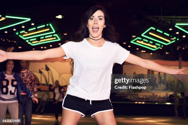 woman having fun at roller disco - white t shirt fotografías e imágenes de stock