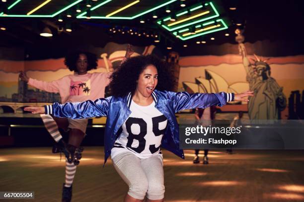 woman having fun at roller disco - woman roller skating stock pictures, royalty-free photos & images