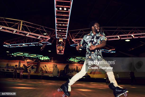 man having fun at roller disco - roller skates stock pictures, royalty-free photos & images