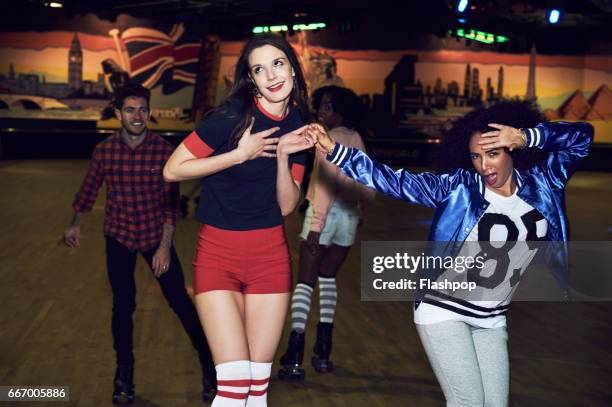 friends having fun at roller disco - pull a face stock pictures, royalty-free photos & images