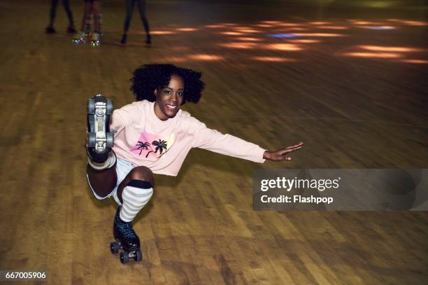 woman having fun at roller disco - kneesock stockfoto's en -beelden