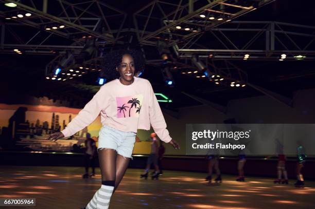 woman having fun at roller disco - black roller skating stock pictures, royalty-free photos & images