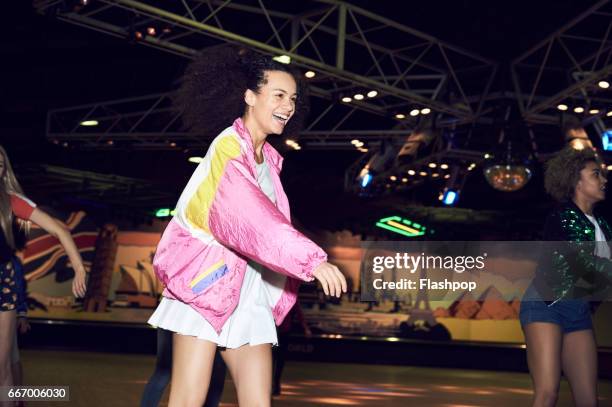 woman having fun at roller disco - women wearing short skirts stock-fotos und bilder