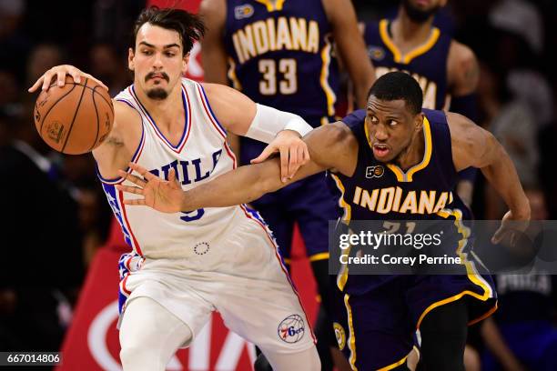 Dario Saric of the Philadelphia 76ers and Thaddeus Young of the Indiana Pacers fight for the ball during the fourth quarter at the Wells Fargo Center...