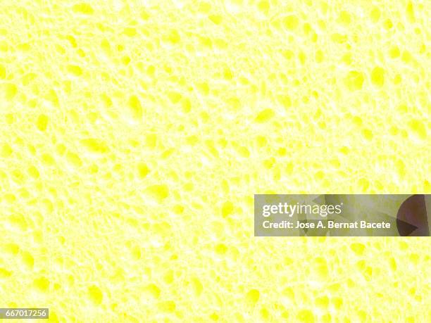 full frame of coarse and wavy textures of colored foam, yellow background - abstracto photos et images de collection