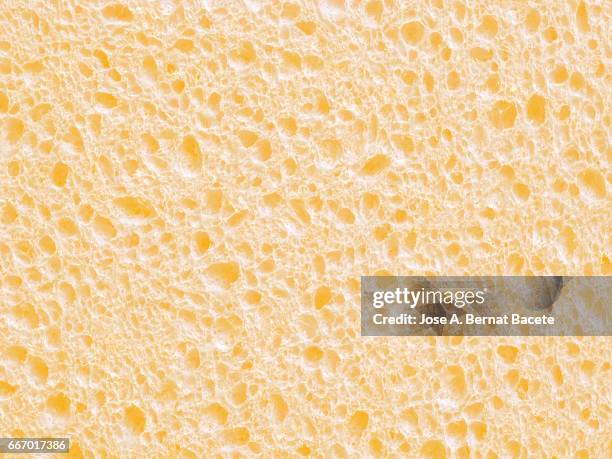 full frame of coarse and wavy textures of colored foam, yellow background - abstracto photos et images de collection