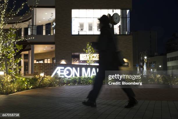 Pedestrian walks past an Aeon shopping mall, operated by Aeon Mall Co., a unit of Aeon Co., in Tokyo, Japan, on Monday, April 10, 2017. Aeon Co.,...