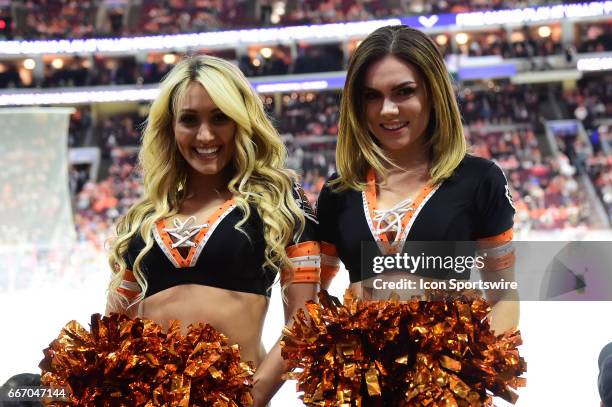 Philadelphia Flyers Ice Girls smile during a National Hockey League game between the Carolina Hurricanes and the Philadelphia Flyers at the Wells...