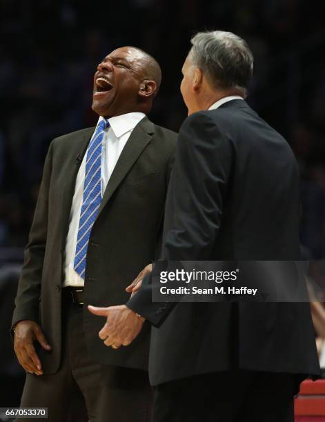 Head coach Doc Rivers of the LA Clippers laughs with head coach Mike D'Antoni of the Houston Rockets during the second half of a game at Staples...