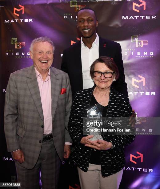 Gorgui Dieng of the Minnesota Timberwolves poses for a photo with honorees Roger and Nancy McCabe during MATTER Presents: The Gorgui Dieng Project on...