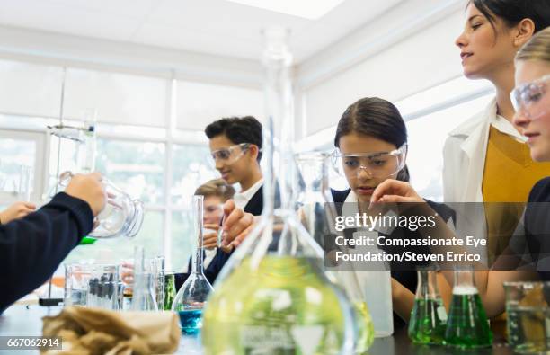 teacher and students working in chemistry lab - science lab school stock-fotos und bilder