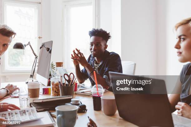 group of young people discussing working - web designer stock pictures, royalty-free photos & images