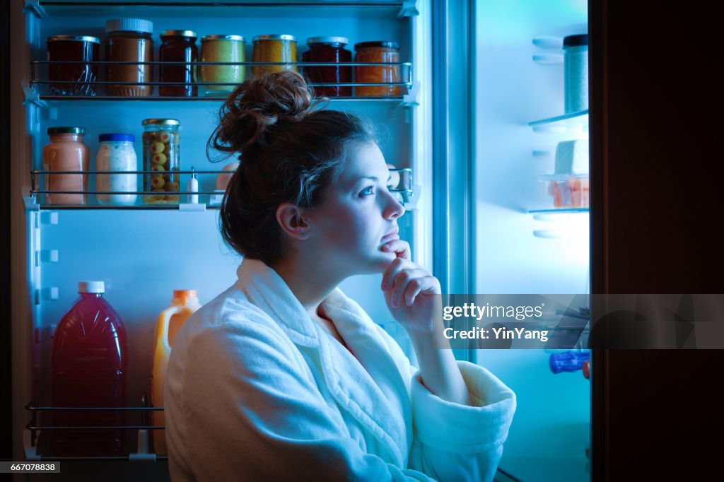 Dieting Young Woman Late Night Making Choices on What to Eat