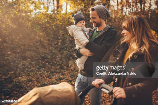 happy family spending time outdoors - baby stroller imagens e fotografias de stock
