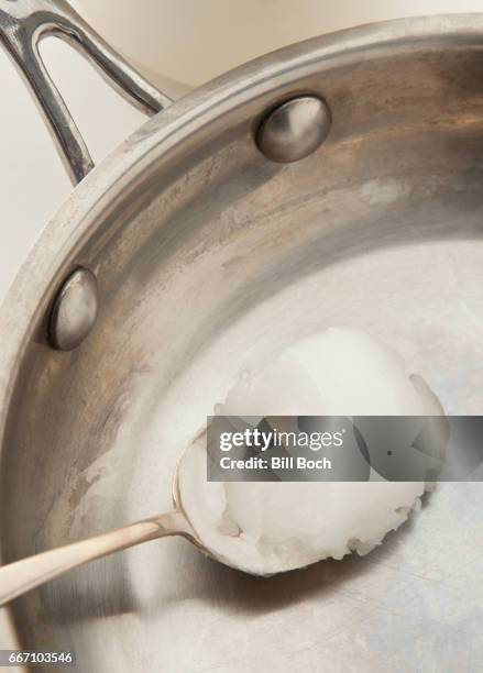 spoonful of coconut oil in a well used frying pan - coconut oil 個照片及圖片檔