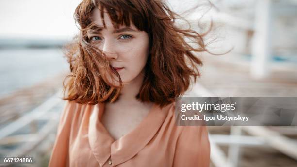 caucasian woman walking near the sea - young women walking stock pictures, royalty-free photos & images