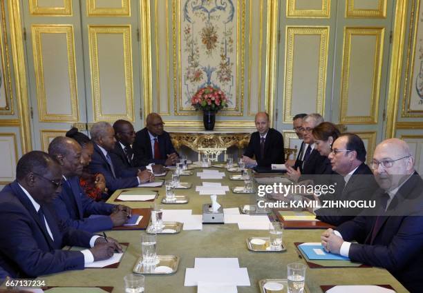 French President Francois Hollande , Minister for Ecology, Sustainable Development and Energy Segolene Royal and Finance Minister Michel Sapin meet...