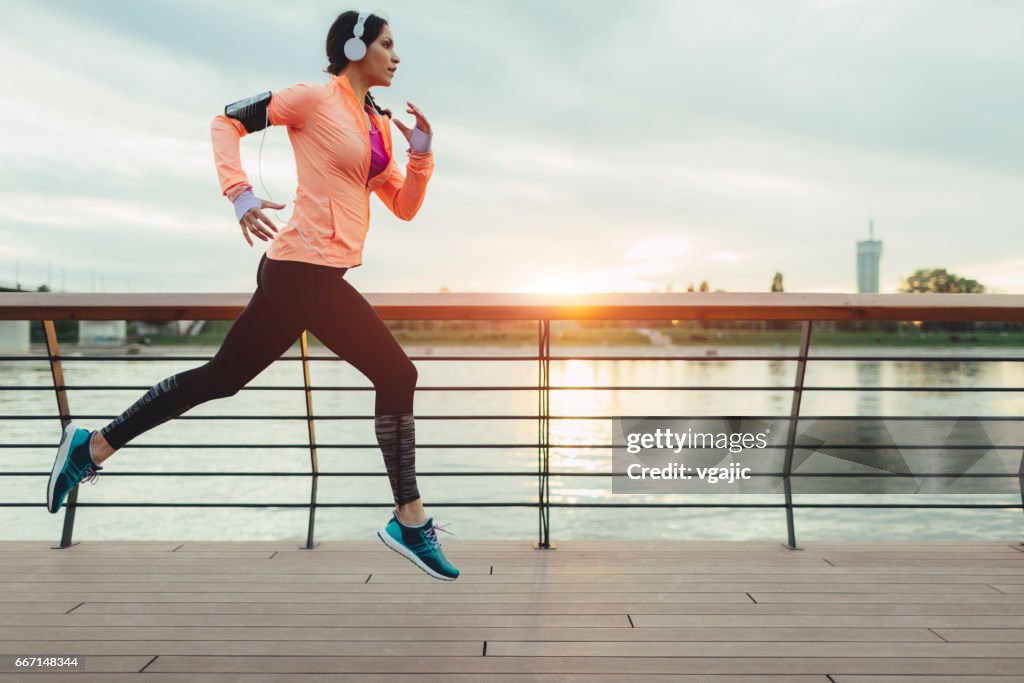 Woman running on riverside