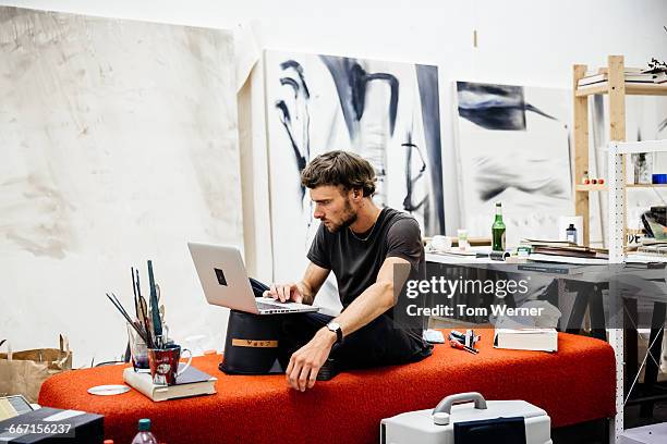 artist with laptop in his atelier - male artist stock pictures, royalty-free photos & images