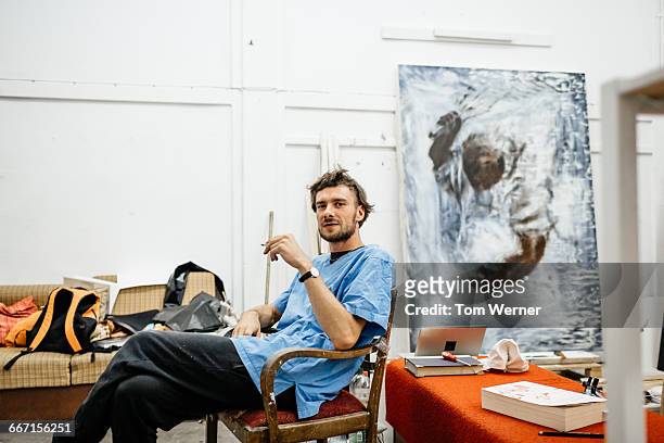 artist sitting in atelier - male artist stock pictures, royalty-free photos & images