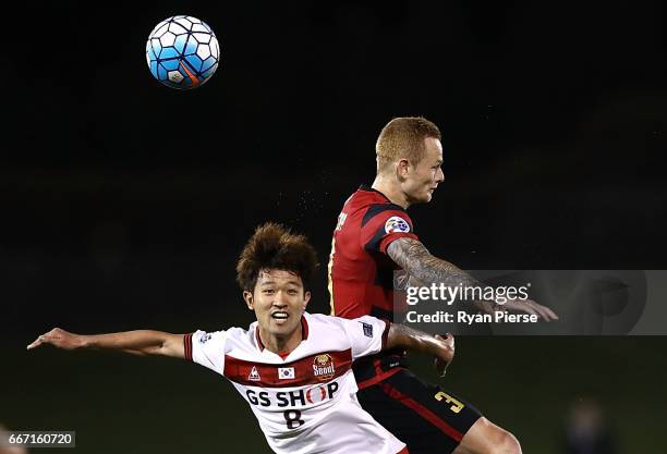 Lee Sang-ho of FC Seoul competes for the ball against Jack Clisby of the Wanderers during the AFC Champions League match between the Western Sydney...