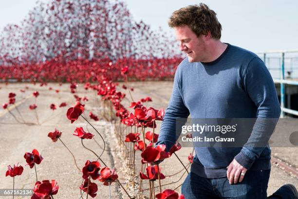 Artist Paul Cummins views his poppy sculpture "Wave" at Barge Pier, Shoeburyness, Southend-on- Sea as part of a UK-wide tour organised by 14-18 NOW...