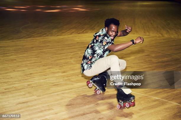 man having fun at roller disco - showing off fotografías e imágenes de stock