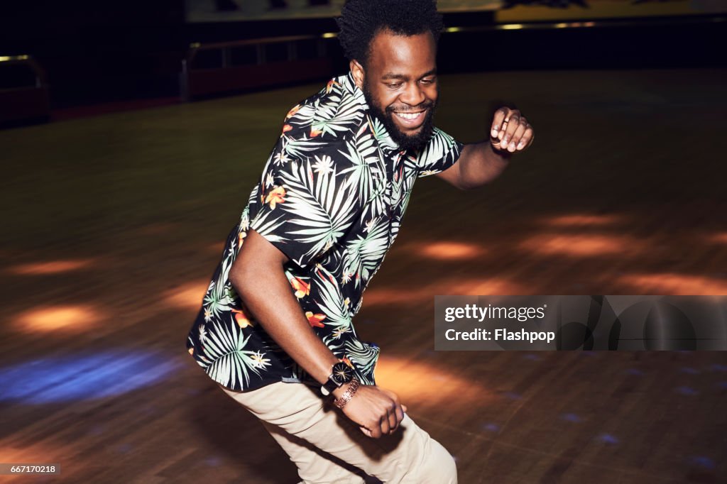 Man having fun at roller disco