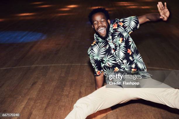 man having fun at roller disco - millennials having fun stockfoto's en -beelden