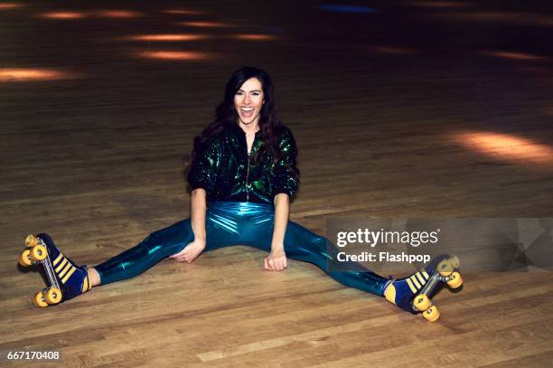 woman having fun at roller disco - woman roller skating stock pictures, royalty-free photos & images