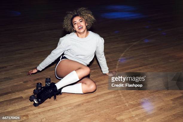 woman having fun at roller disco - indoor skating stock pictures, royalty-free photos & images