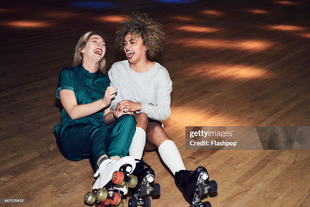 Two friends having fun at roller disco
