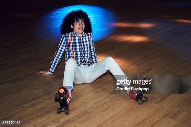 man having fun at roller disco - tanzfläche stock-fotos und bilder