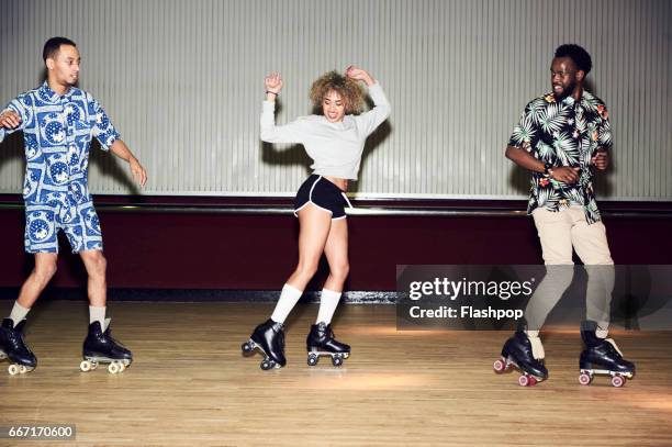 friends having fun at roller disco - roller skating stock pictures, royalty-free photos & images