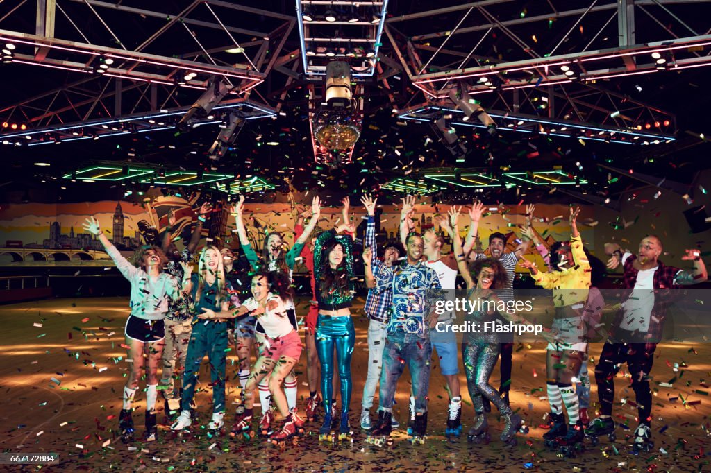 Group of friends celebrating at roller disco