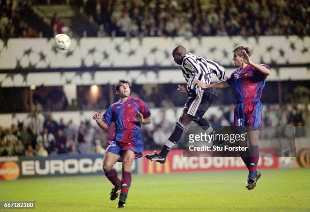 Newcastle United striker Faustino Asprilla leaps between Barcelona players Nadal and Sergi Barjuan to head the third Newcastle goal and his hat trick...