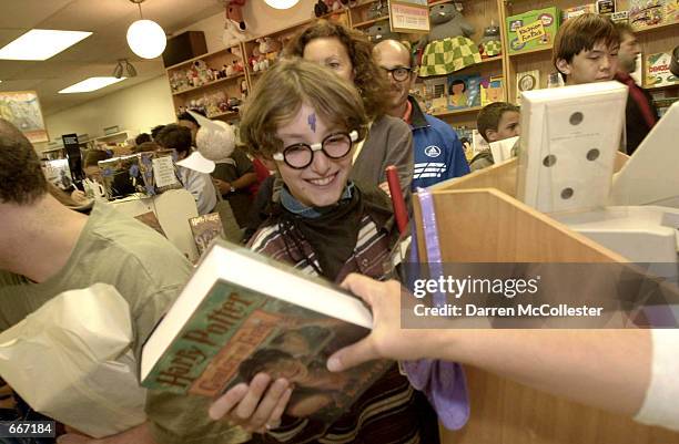 Fan gets his "Harry Potter and the Goblet of Fire" book, July 8 at The Children's Book Shop in Brookline, MA . Hundreds of people waited in line for...