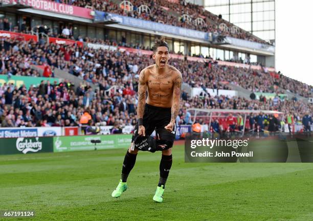 Roberto Firmino of Liverpool celebrates after scoring during the Premier League match between Stoke City and Liverpool at Bet365 Stadium on April 8,...