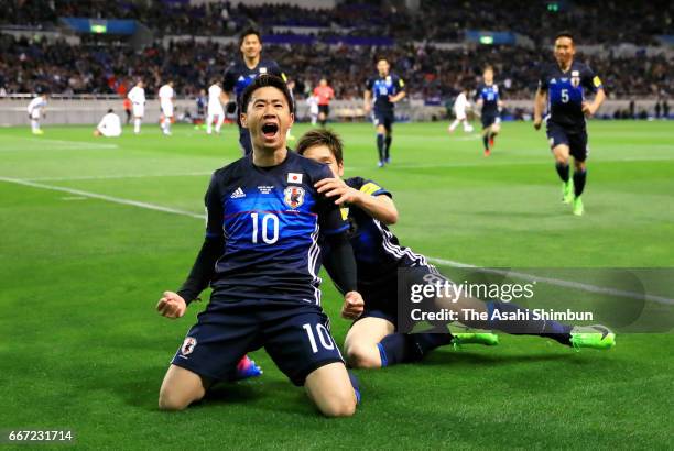 Shinji Kagawa of Japan celebrates scoring the opening goal during the 2018 FIFA World Cup Qualifier match between Japan and Thailand at Saitama...