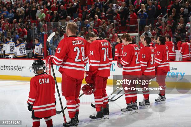 Bryan Bickell of the Carolina Hurricanes and teammates are photographed during the National Anthem prior to an NHL game against the St. Louis Blues...