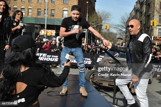 William Valdes greets Vin Diesel as he and Michelle Rodriguez visit Washington Heights on behalf of "The Fate Of The Furious" on April 11, 2017 in...
