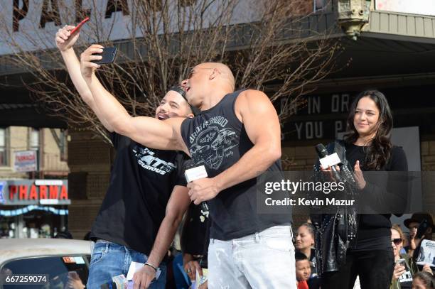 William Valdes poses with Michelle Rodriguez and Vin Diesel as they visit Washington Heights on behalf of "The Fate Of The Furious" on April 11, 2017...