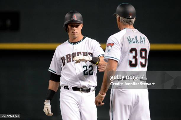 Jake Lamb of the Arizona Diamondbacks high fives first base coach Dave McKay after singling against the Cleveland Indians in the fourth inning at...