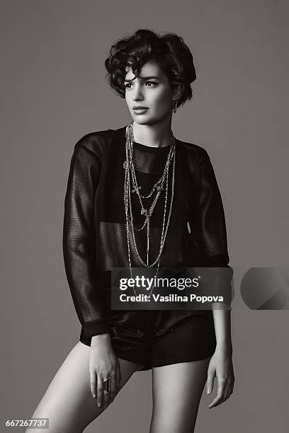 fashionable woman posing in studio - women wearing see through clothing stockfoto's en -beelden